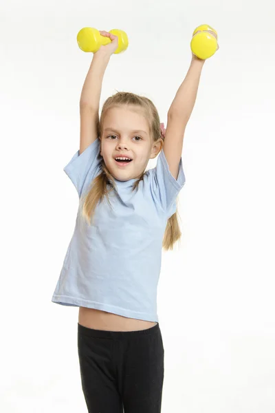 The girl raised her two dumbbells — Stock Photo, Image