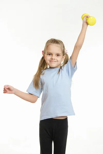 Six year old girl held up a dumbbell — Stock Photo, Image