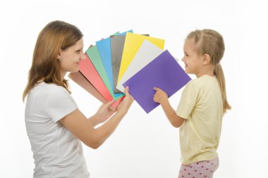 child shows colors the image in hands of women clipart