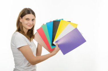 young girl holding a picture with solid colors
