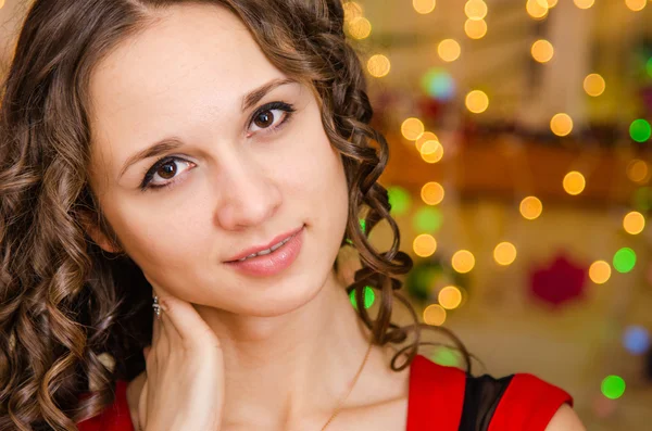 Portrait girl on a background of blurred Christmas lights — Stok fotoğraf
