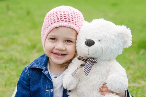 Girl hugging a teddy bear picnic — Stock Photo, Image