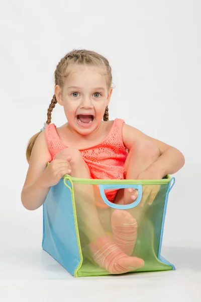 Happy girl in a box for toys — Stock Photo, Image