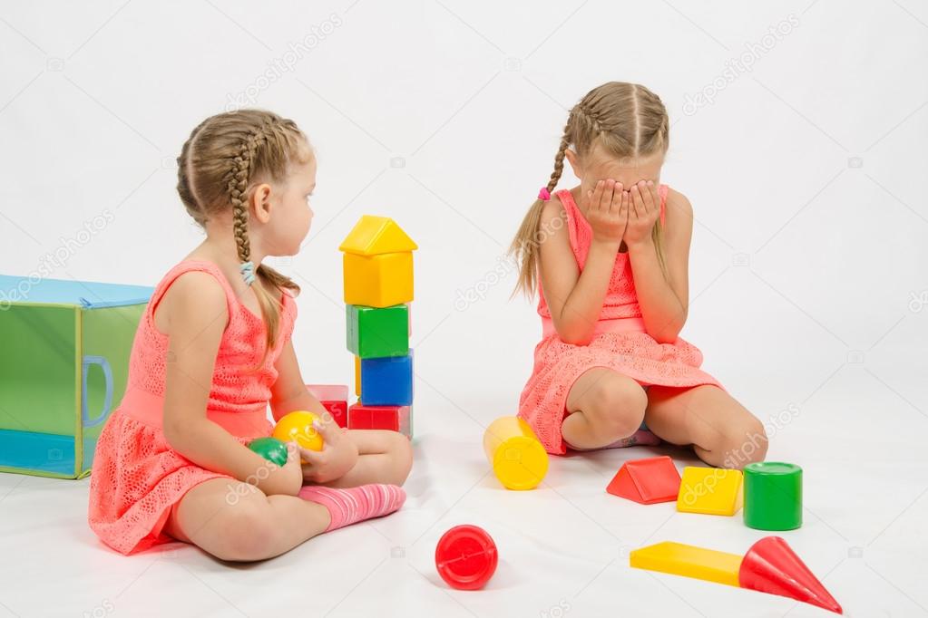 Girl hurt another girl playing with toys