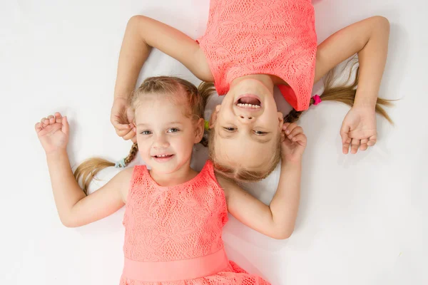 Two sisters lying on the back jack — Stock Photo, Image