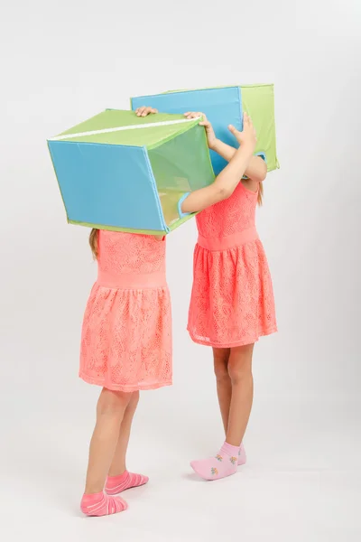 Two girls play about putting on a head box — Stock Photo, Image