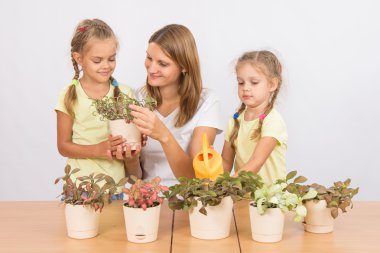 Mom and daughter caring for plants clipart