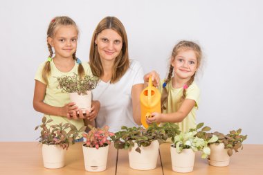 Mom and daughter Fitton watered from a watering can clipart