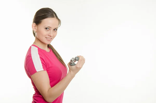 Beautiful female athlete flexing muscles of the hand expanders — Stock Photo, Image