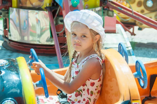 Girl rides on the carousel — Stock Photo, Image