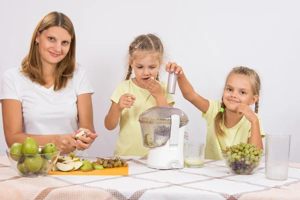 Flicka gnager päron tills mamma och syster klämde juice i en juicepress — Stockfoto