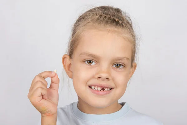 Portrait d'une fille avec une dent tombée dans la main — Photo