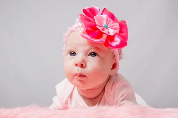 The two-month girl lying on her stomach her head high — Stock Photo, Image