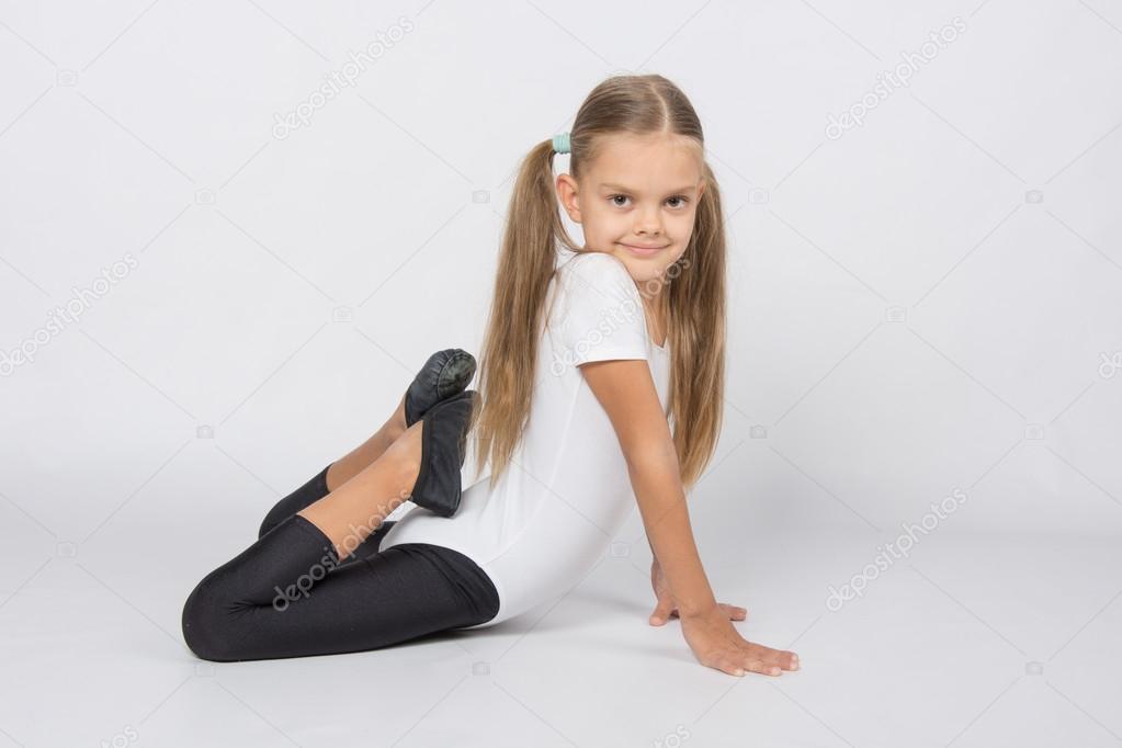 Girl gymnast performs an exercise fish