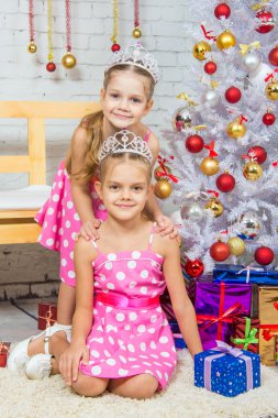 Two girls at the beauty of Christmas trees
