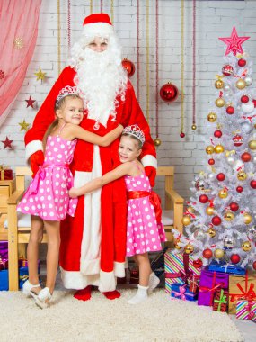 Children hugging grandfather frost from Christmas trees