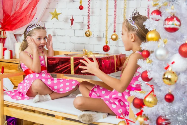 Girl surprised big red Christmas gifts — Zdjęcie stockowe