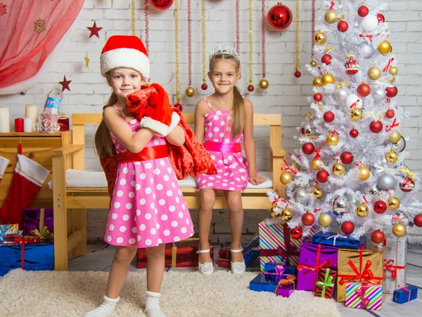 Girl dressed as Santa Claus brought gifts in the bag, another girl rejoices — ストック写真