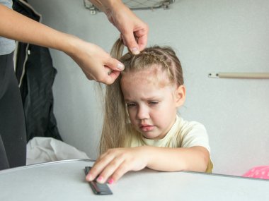 Four-year girl cries in pain when my mother combing her hair