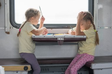 Two girls painted for the side table in the second-class train carriage