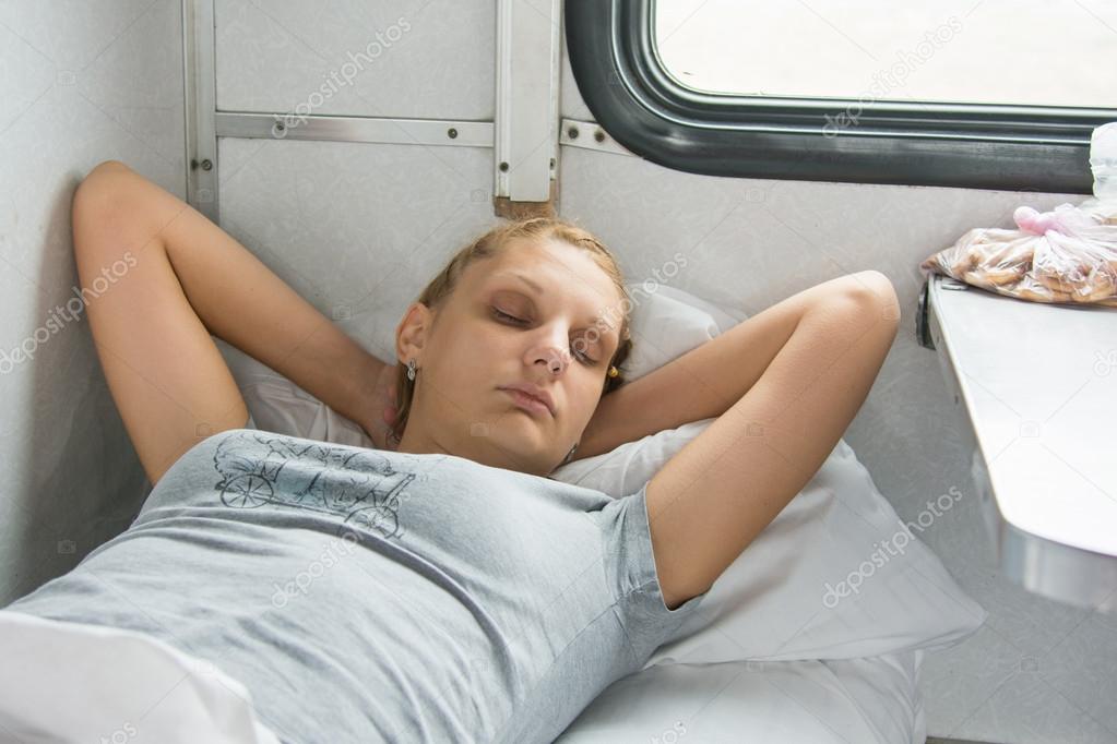 Young girl sleeping on a train