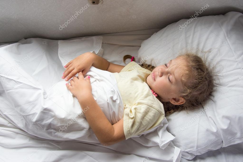 Girl sleeping on a cot in a train
