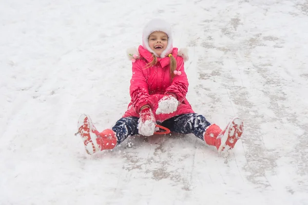 Girl having fun rolling ice slides — Stock Photo, Image