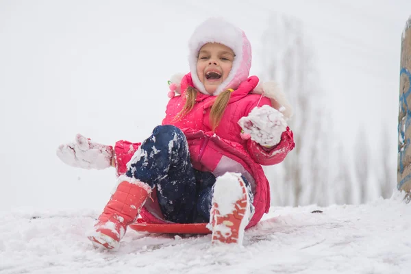Girl shouting and rejoicing rolling ice slides — Stock Photo, Image
