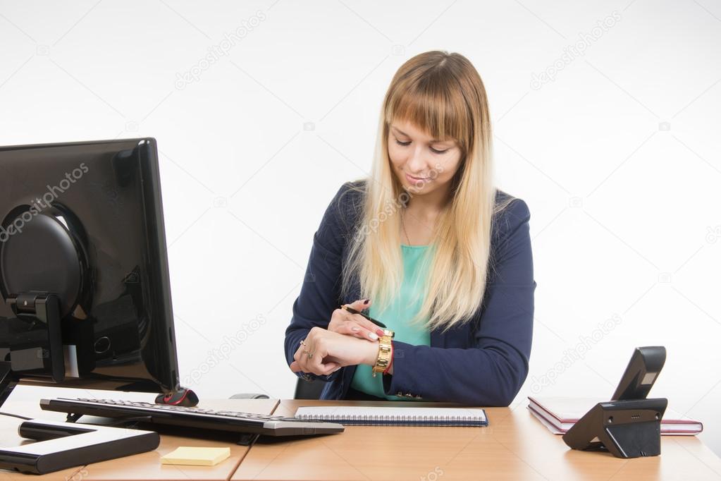 Business woman looked at his watch waiting for the client in the office