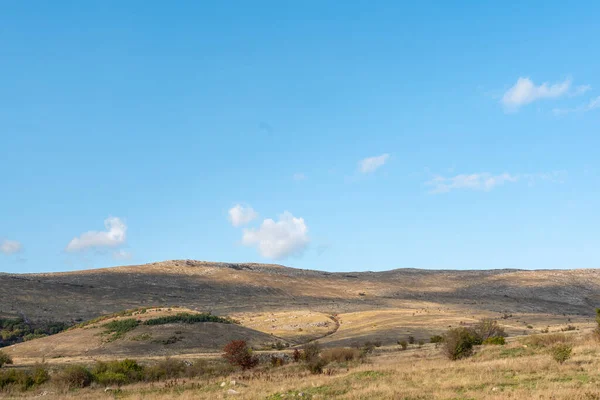 ブルガリアの田舎の岩の丘秋の色合い晴れた日緑暖かい森のコピースペーステキストブルースカイ — ストック写真