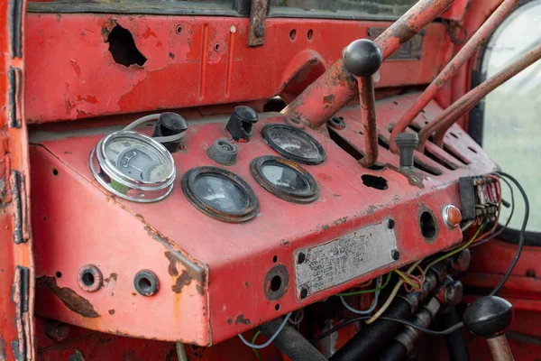 Closeup dashboard gages of old rusty red russian tractor during autumn harvest agriculture technology transportation vehicle in rural Bulgaria