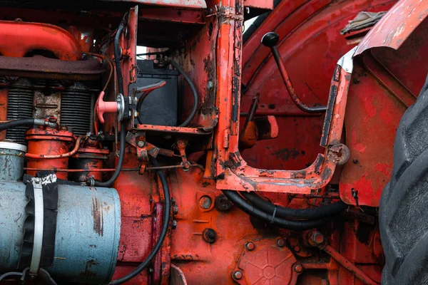 Vintage engine tractor system part old diesel engine heavy machine closeup grunge rusty oil dirty red abstract detail with sharp selective focus Stock Image