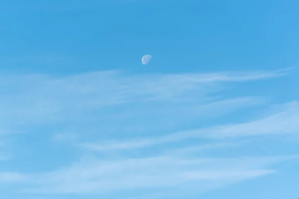 Bright blue sky with moon and clouds, sky and moon
