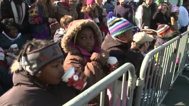 Дети пьют горячий шоколад в ожидании парада — стоковое видео