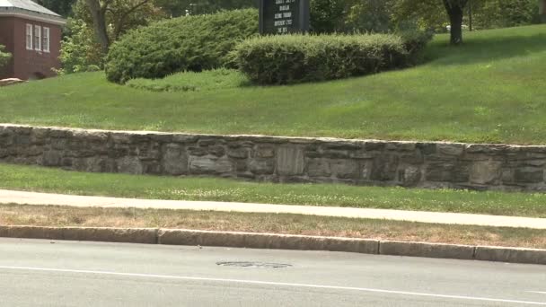 Bicicleta andando para baixo calçada com parede de pedra ao longo do lado dele — Vídeo de Stock