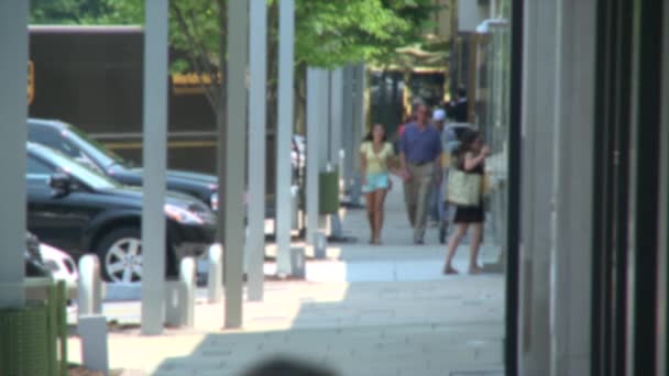 Couple holding hands while walking along storefronts — Stock Video