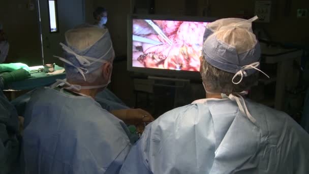 Surgeons performing robotic operation — Stock Video