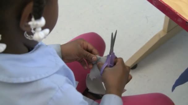 Estudiante de la escuela primaria corte de tela con tijeras — Vídeos de Stock