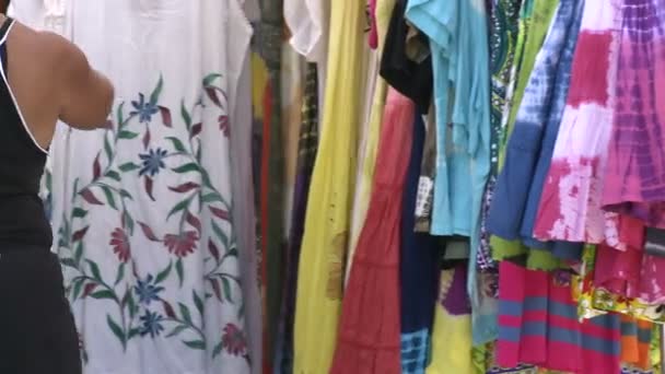 Mirando vestidos en una feria de artesanía . — Vídeo de stock