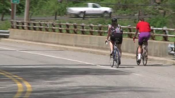 Cyclists riding along road (8 of 9 ) — стоковое видео