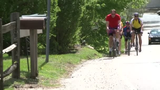 Cyclists riding along road (2 of 9 ) — стоковое видео