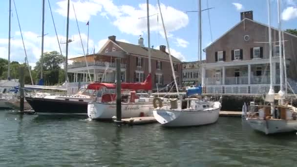 Sail boats moored in front of homes. — Stock Video