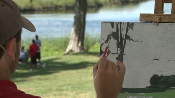 Man painting beautiful portrait of a landscape — Stock Video