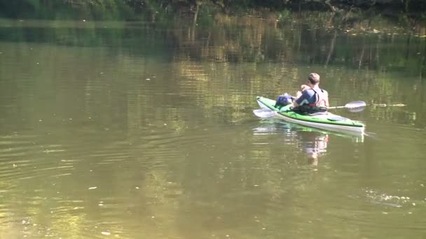 Людина на байдарках, плаваючі на озері — стокове відео