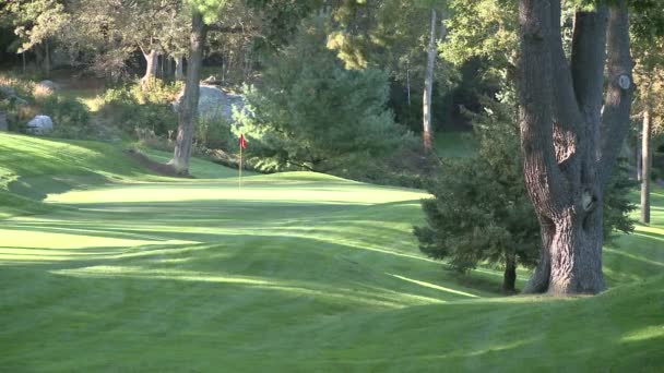 Guardando attraverso una zona collinare ad un putting green — Video Stock