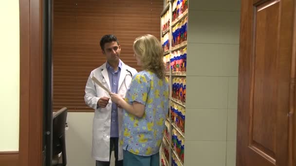 Доктор консультується з асистентом або медсестрою — стокове відео