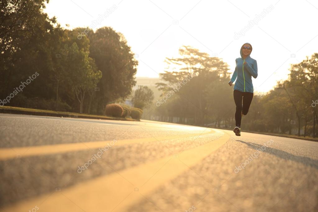 young woman running  at road