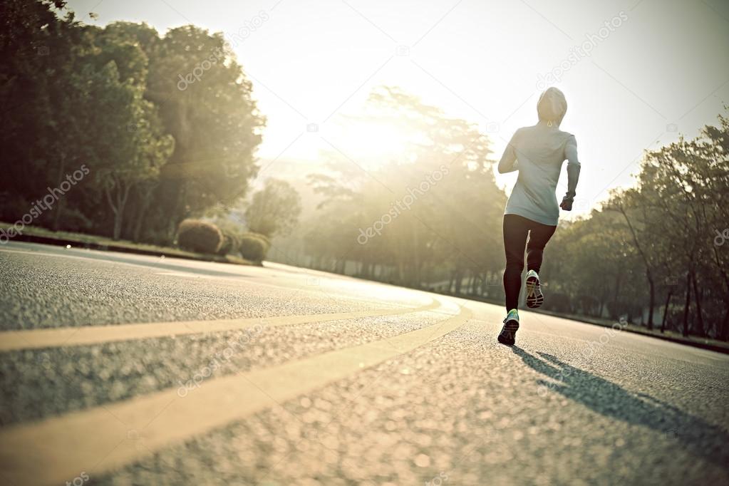 young fitness woman at road