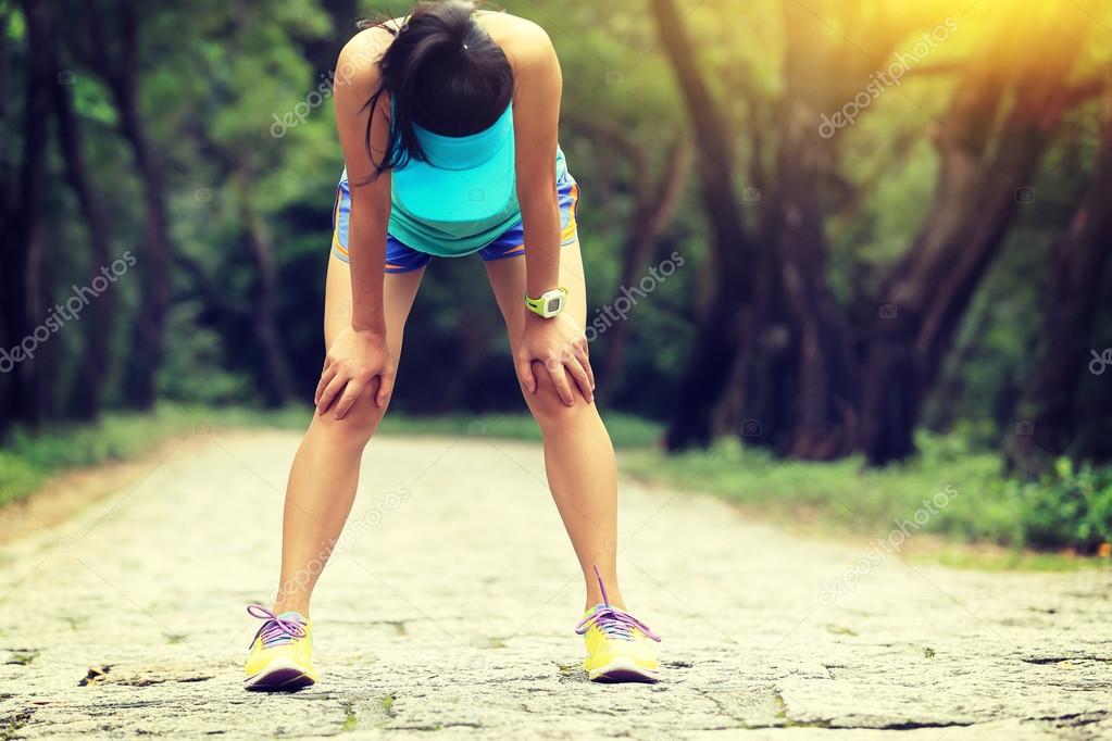 Tired woman runner Stock Photo by ©lzf 109149528