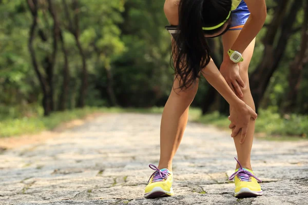 Woman runner holding knee — Stock Photo, Image